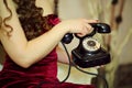 Hands of woman in red dress hold retro telephone Royalty Free Stock Photo