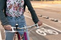 Hands of woman riding bicycle by the bike path Royalty Free Stock Photo