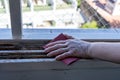 A Hands of a woman with a sandpaper sanding a window frame before painting. Empowered woman concept. Landscape orientation Royalty Free Stock Photo