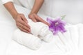 Hands of woman setting wellness decoration in spa salon backgrou