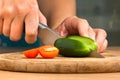 Hands of woman slicing cucumber on the cutting board Royalty Free Stock Photo