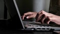 Woman's hands typing fast on a laptop keyboard Royalty Free Stock Photo