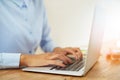 Hands of woman typing on laptop