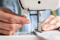 Hands of a woman using a sewing machine Royalty Free Stock Photo