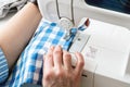 Hands of a woman using a sewing machine Royalty Free Stock Photo