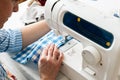 Hands of a woman using a sewing machine in tailor workshop Royalty Free Stock Photo