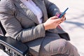 hands of a woman using wheelchair using phone