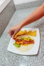 Hands of woman who is preparing a taco