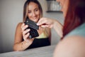 Hands, woman and credit card tap to pay on electronic machine for wireless transaction at cafe. Hand of female in Royalty Free Stock Photo