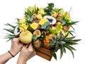 Hands of women decorate the unique gift wooden box with flowers and fruits isolated on white background