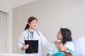 Hands woman doctor reassuring her female asian patient in hospital room,Doctor giving a consultation and encouragement to patient Royalty Free Stock Photo