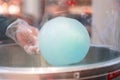 The hands of women holding blue cotton candy