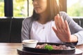 Hands woman refusing beef steak in restaurant,No meal,Vegetarian and vegan concept