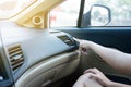 Hands of woman turning on car air conditioning system,Button on dashboard in car panel Royalty Free Stock Photo