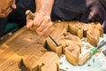 Hands woodcarver while working with the tools