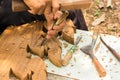 Hands woodcarver while working with the tools