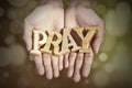 Hands with a word of pray in bokeh background Royalty Free Stock Photo