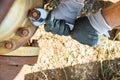 Hands with Work Gloves Holding a Wrench and Tighten very Rusty Bolts Royalty Free Stock Photo