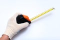 Hands of a worker, builder in protective gloves halding a ruler, using tape measure against white background Royalty Free Stock Photo