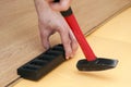 Hands of a worker mounting laminated floor Royalty Free Stock Photo