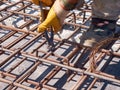 Hands of worker tying reinforcement rebars with haywire Royalty Free Stock Photo
