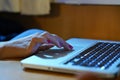 Hands working on the computer keyboard