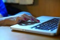 Hands working on the computer keyboard