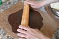 Mom rolls dough. chocolate dough. Hands working with dough preparation recipe bread. Female hands making dough for pizza. Woman`s Royalty Free Stock Photo