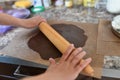 Mom rolls dough. chocolate dough. Hands working with dough preparation recipe bread. Female hands making dough for pizza. Woman`s Royalty Free Stock Photo