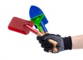 Hands in working gloves holding gardening tools rake shovel Royalty Free Stock Photo