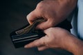 Hands of a working man counting dollar bills in an empty wallet. Poverty concept. dismissal or accumulation of money, withdrawal