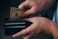 Hands of a working man counting dollar bills in an empty wallet. Poverty concept. dismissal or accumulation of money, withdrawal