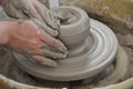 Hands working on pottery wheel