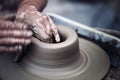 Hands working on pottery wheel , artistic toned Royalty Free Stock Photo