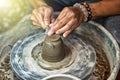 Hands working on pottery wheel