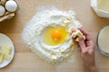 Hands working with shortbread dough. Preparation cake making from ingredients on wooden table background. Flat lay. Top view Royalty Free Stock Photo