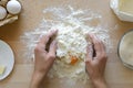 Hands working with shortbread dough. Preparation cake making from ingredients on wooden table background. Flat lay. Top view Royalty Free Stock Photo