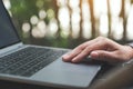 Hands working , touching and typing on laptop keyboard with blur nature background