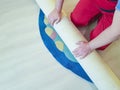 Hands working, unfolding work carpet on the floor of the house Royalty Free Stock Photo