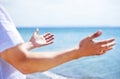 Hands, worship and man at the sea with happiness and praise God for blessing, water and spiritual peace. Person, closeup Royalty Free Stock Photo