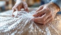 Hands wrapping item with bubble wrap for protection and safety during shipping Royalty Free Stock Photo