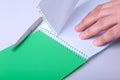 Hands wresting the sheet of paper out of a spiral notebook. Royalty Free Stock Photo