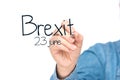 Hands writing brexit