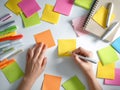 dynamic brainstorming with colorful sticky notes, lively project mapping using markers and various notebooks Royalty Free Stock Photo
