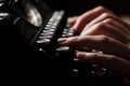 Hands writing on old typewriter over wooden table Royalty Free Stock Photo