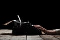 Hands writing on old typewriter over wooden table Royalty Free Stock Photo