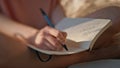 Hands writing personal journal in sunlight closeup. Calm girl rest morning bed Royalty Free Stock Photo