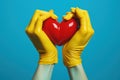 Hands in yellow rubber gloves hold red heart. Generative AI Royalty Free Stock Photo