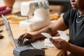 Hands of young African American woman with receit checking payment information Royalty Free Stock Photo