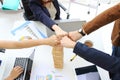 Hands of young business people giving fist bump together to greeting complete dealing in office. Success and teamwork concept. Royalty Free Stock Photo